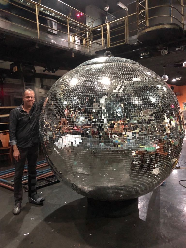 Globo espelhado gigante de cerca de 2 metros ao lado de uma pessoa